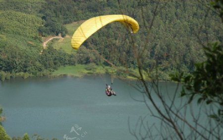 滑翔伞飞行在水面上空图片