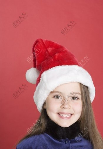 带着圣诞帽的微笑小女孩图片