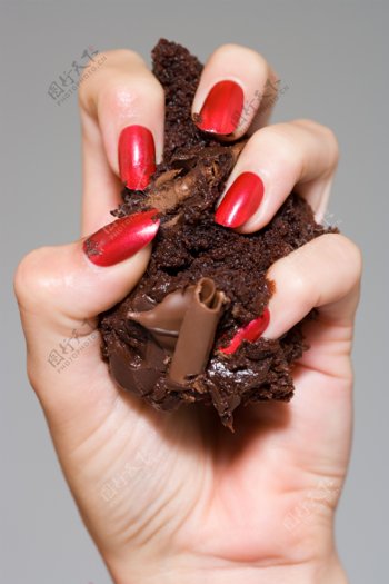 握巧克力糕点的手图片