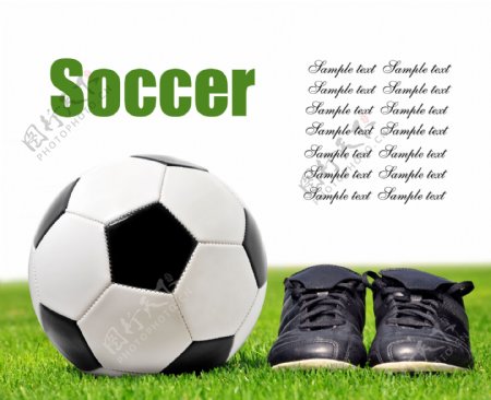 草地上的足球与足球鞋图片