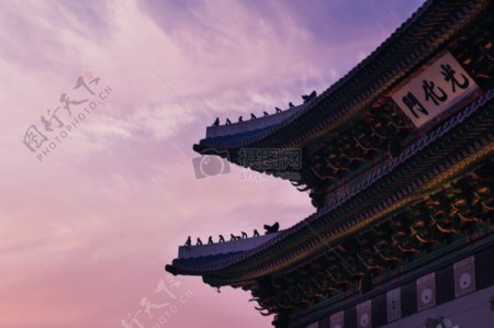 中国寺庙和汉字横幅在橙顶部和紫色的天空多云